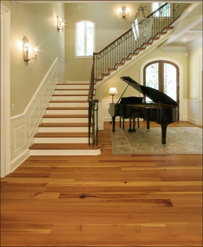 Antique Reclaimed Heart Pine Vertical Grain flooring and matching stair treads in a new Southern home.
