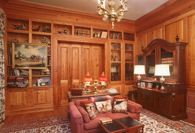 Antique Reclaimed Heart Pine forms the walls, bookcases, doors and floors in a private office.