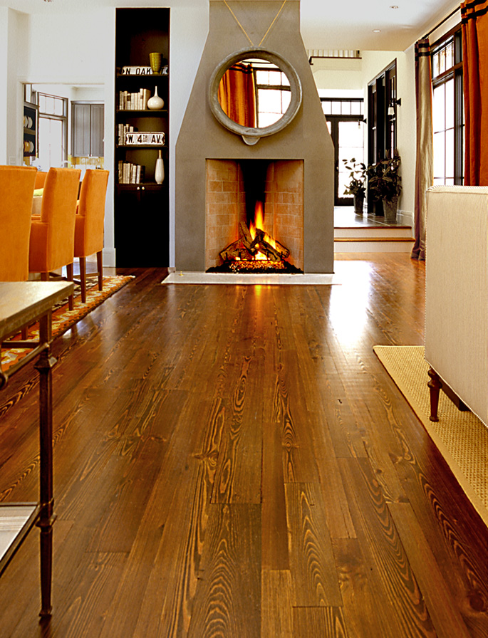 Antique Reclaimed Heart Pine solid wood flooring, stained, in the living and dining spaces of a project house.