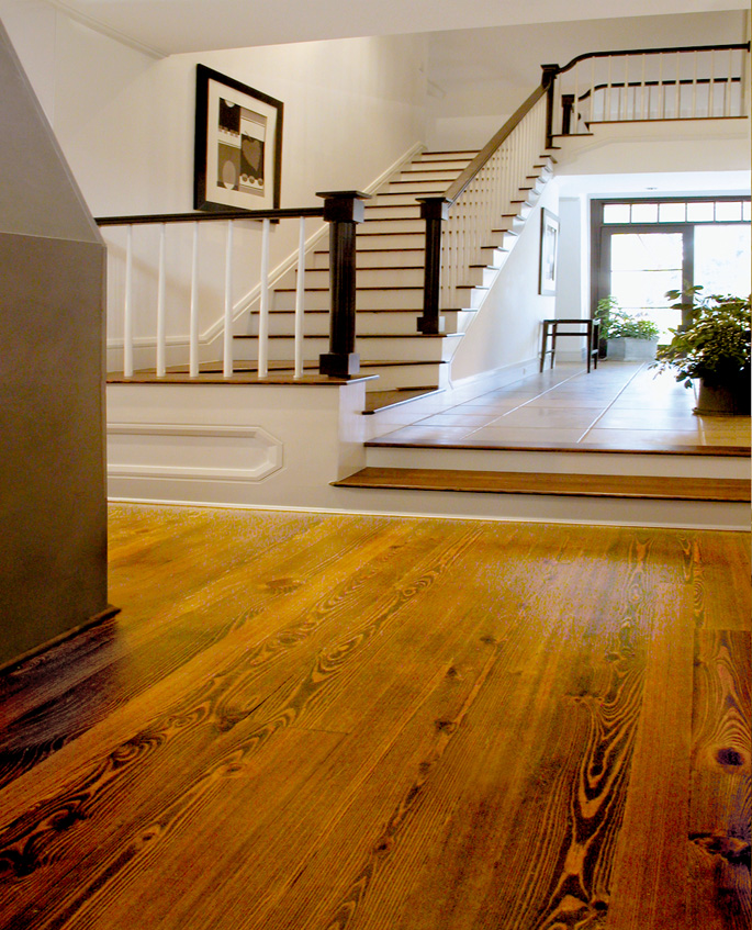 Antique Reclaimed Heart Pine solid wood flooring, select grade, stained, on the stairs and rooms of a project house.