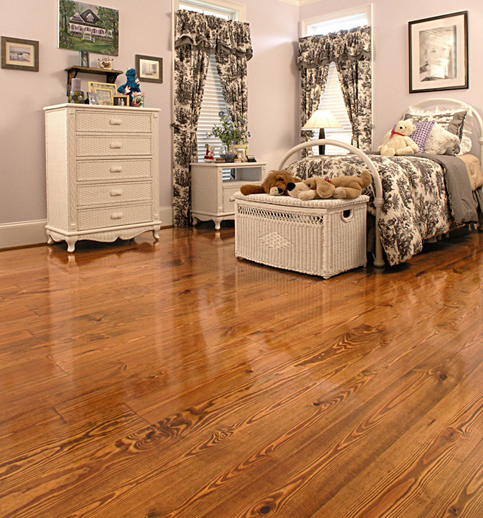 Wide Plank Southern Pine flooring, random widths, stained, in a childÕs bedroom.